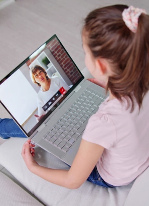 Young person with pink shirt holding tablet for a virtual dental check up.